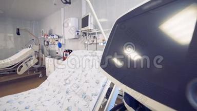 提供设备齐全的医院病房的侧视图，重点是一张床和一个监视器